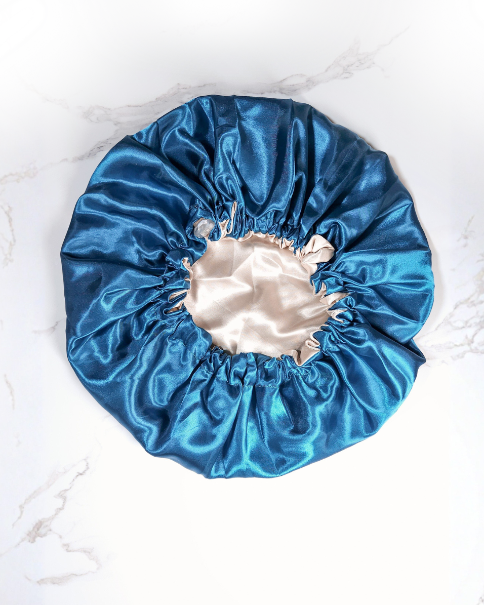 Blue satin bonnet on a white marble surface